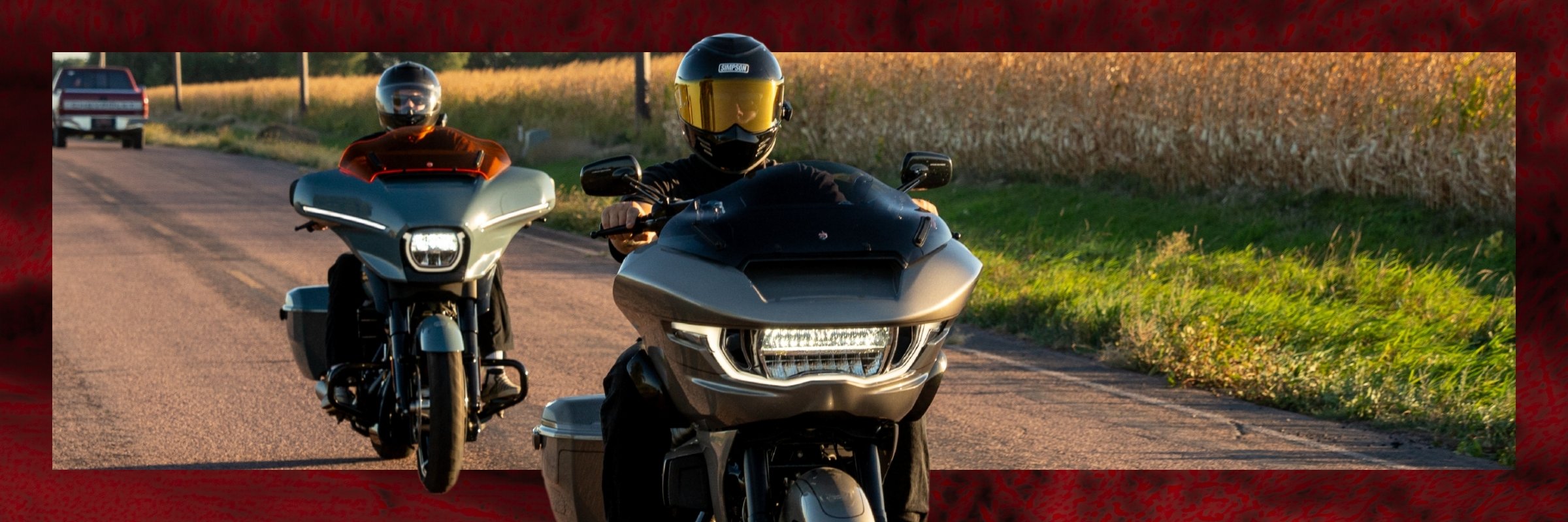 Two people on motorcycles on a country road with text overlay.