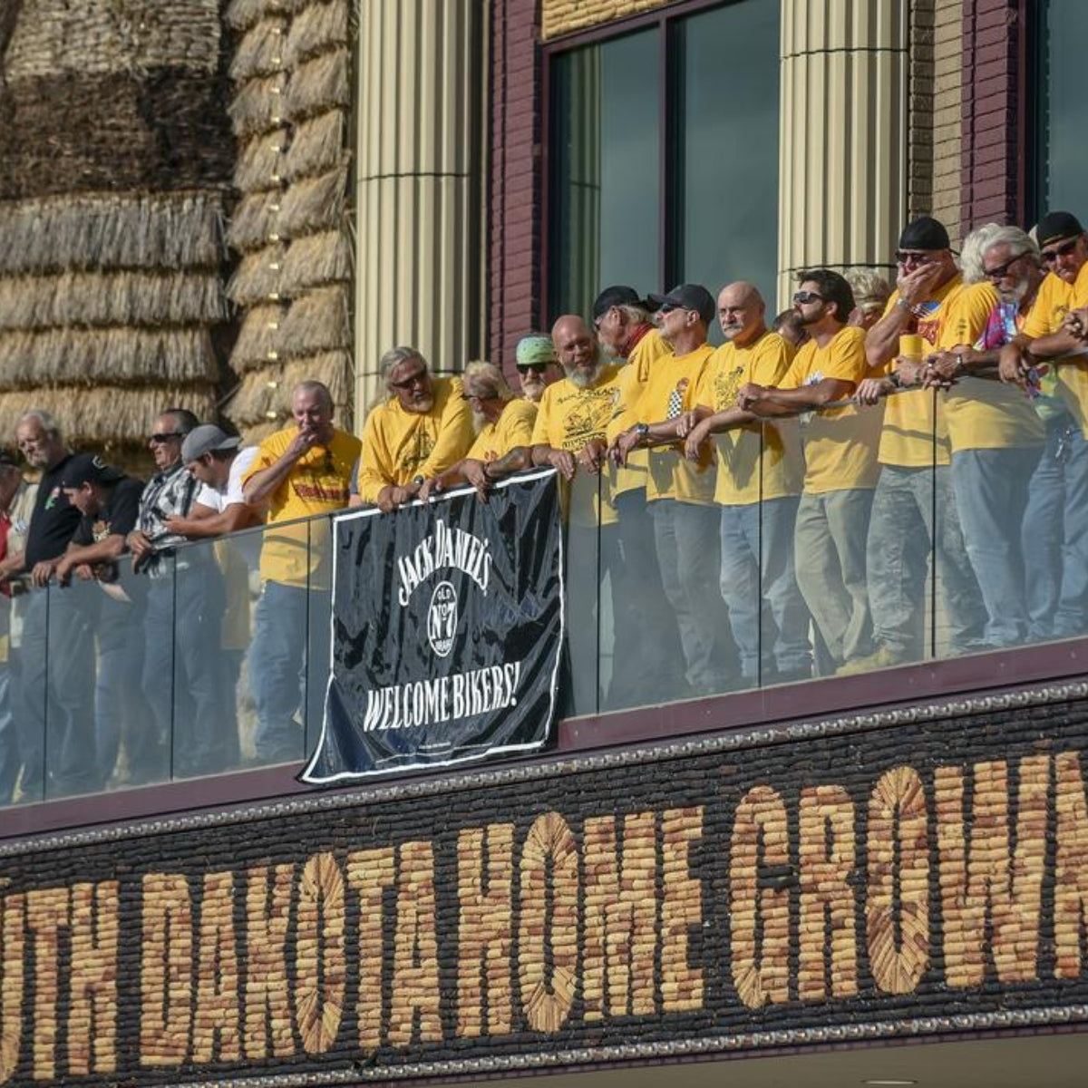 Motorcyclists standing on the balcony of the Corn Palace watching motorcycle stunts during Mitchell's annual Pre-Sturgis party.