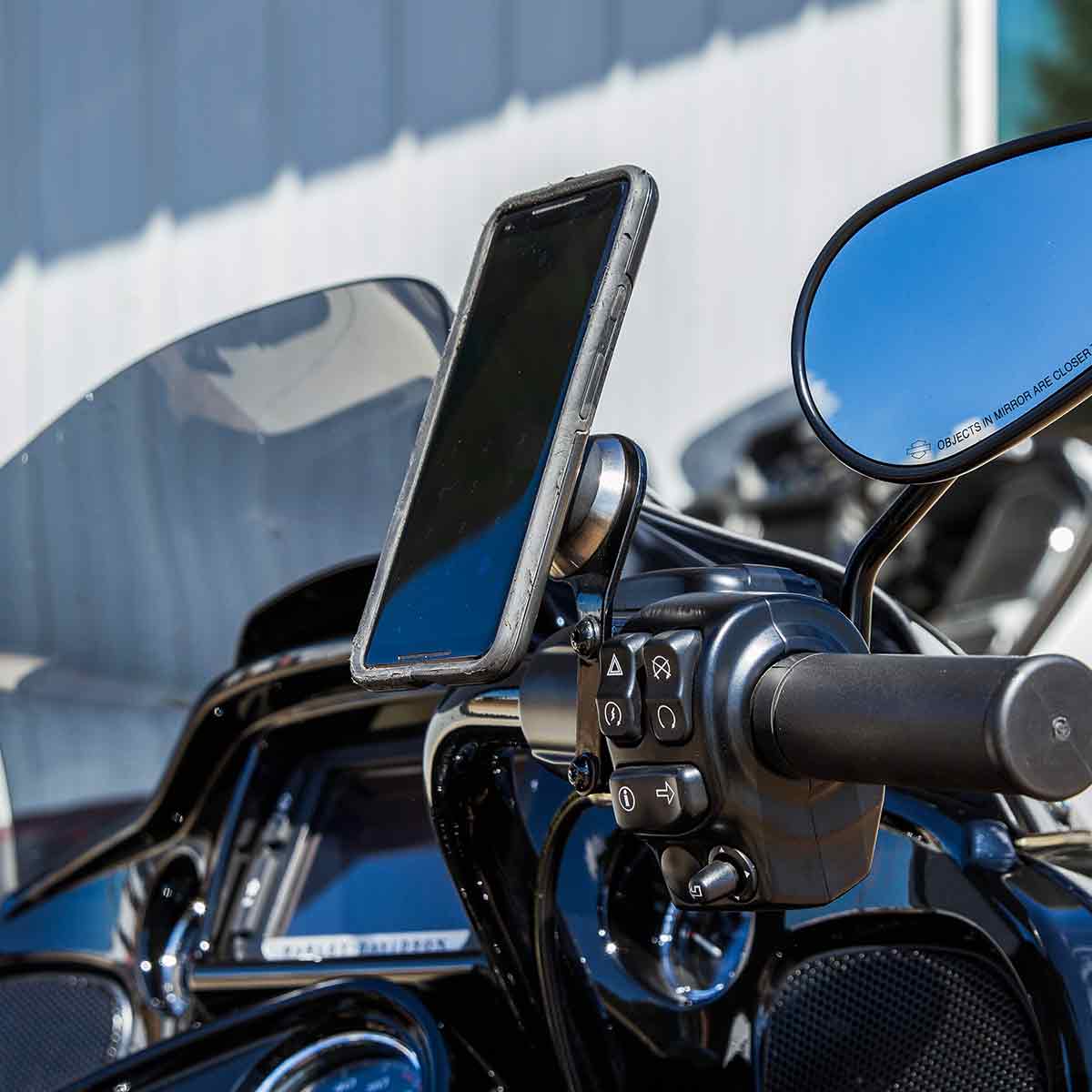 Phone mounted on a motorcycle handlebar with a Klock Werks iOmounts phone mount.