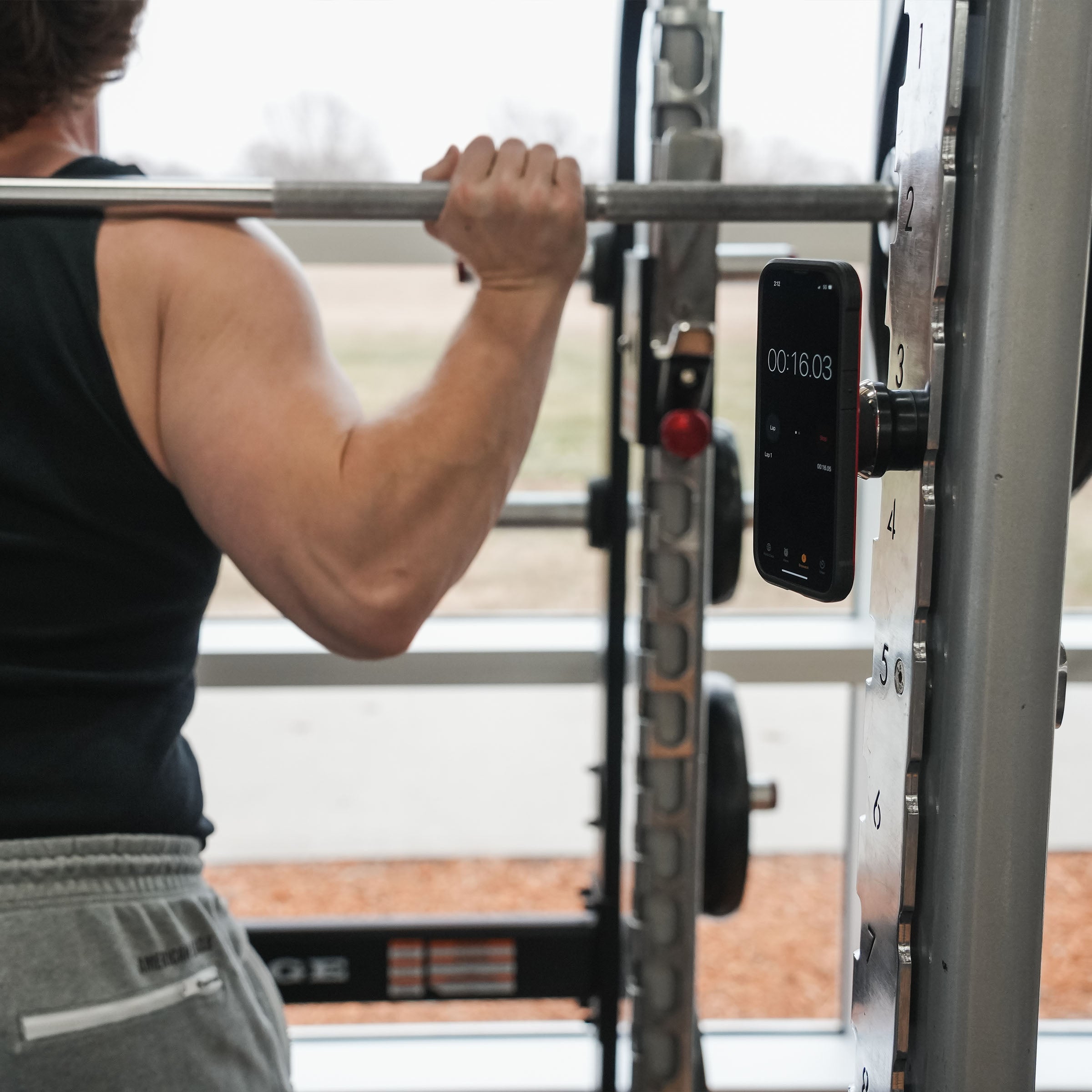 iOkwik Magnetic Universal Phone Mount mounted to rack in the gym(in the gym)