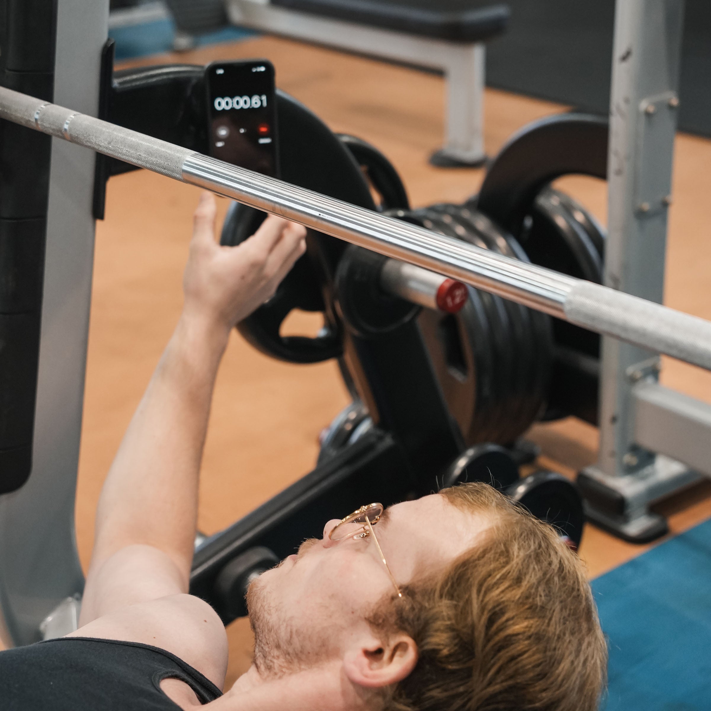 iOkwik Magnetic Universal Phone Mount shown mounted to rack in the gym for intervals(in the gym - easily access your phone for intervals)