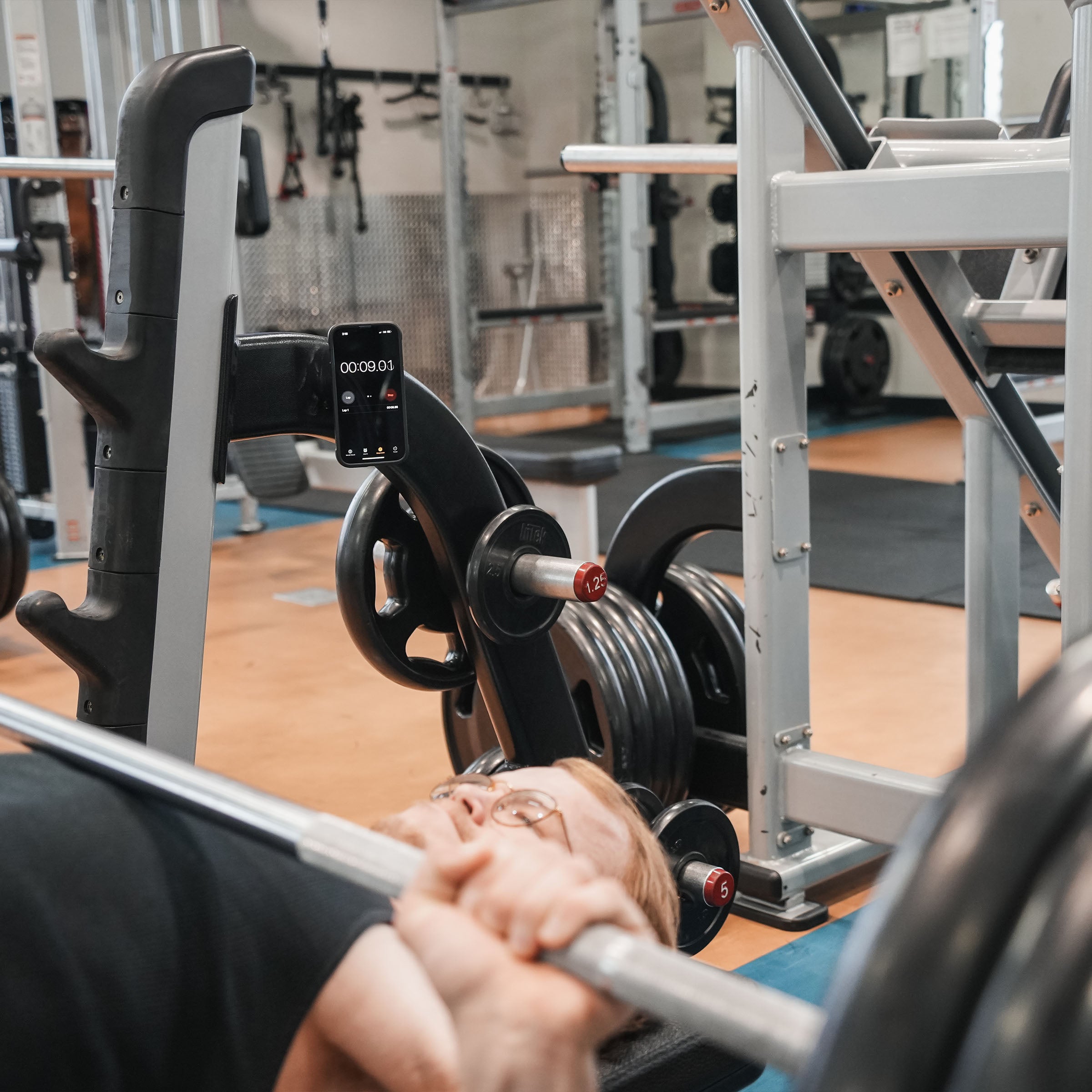 iOkwik Magnetic Universal Phone Mount shown mounted to rack in the gym for intervals(in the gym - easily access your phone for intervals)