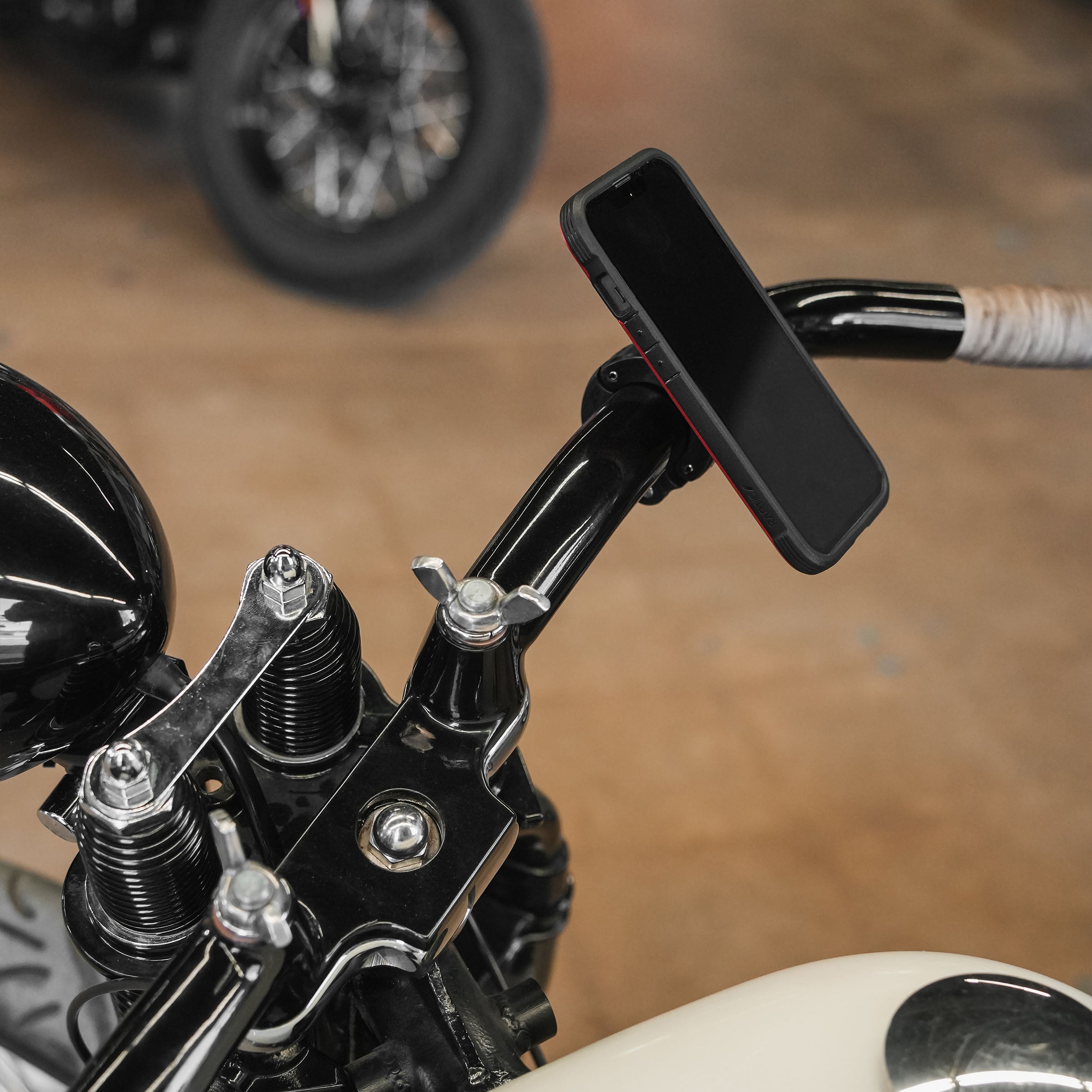1.25" nomad+ Universal Bar Magnetic Phone Mount shown on motorcycle handlebars(1.25" on motorcycle bars)