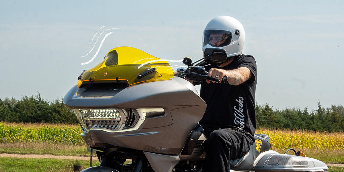 Klock Werks Flare® Windshield shown on a Harley-Davidson with drawn movements of how the air is pushed around the rider