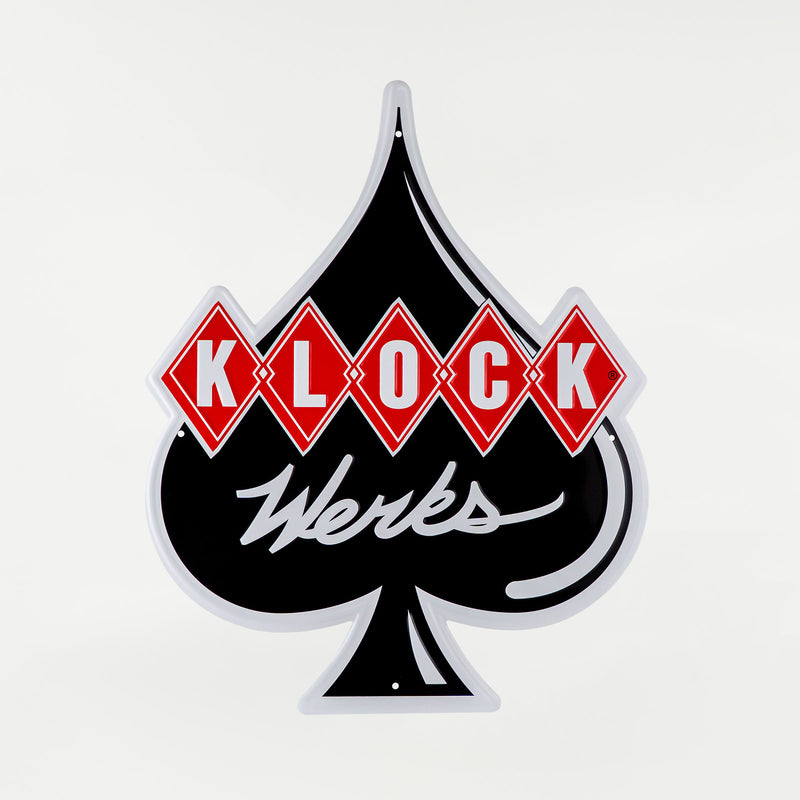 A vintage-style metal sign featuring a black spade with red diamonds containing the letters 'K', 'L', 'O', 'C', 'K' and white script text reading 'Werks' underneath, shown on a light gray background.