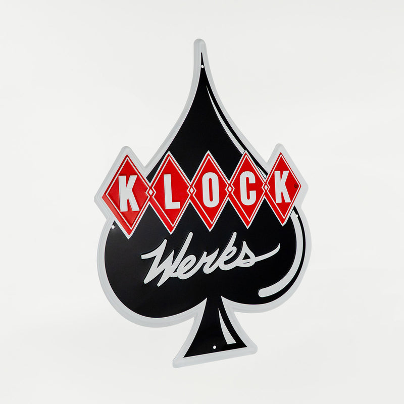 A vintage-style black spade sign with red diamond shapes across the upper half containing the white text 'KLOCK' and white cursive 'Werks' script below, shown on a plain light background.