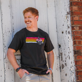 Retro Stripe Logo T Jacob is wearing a Large Red Retro Stripe Logo T